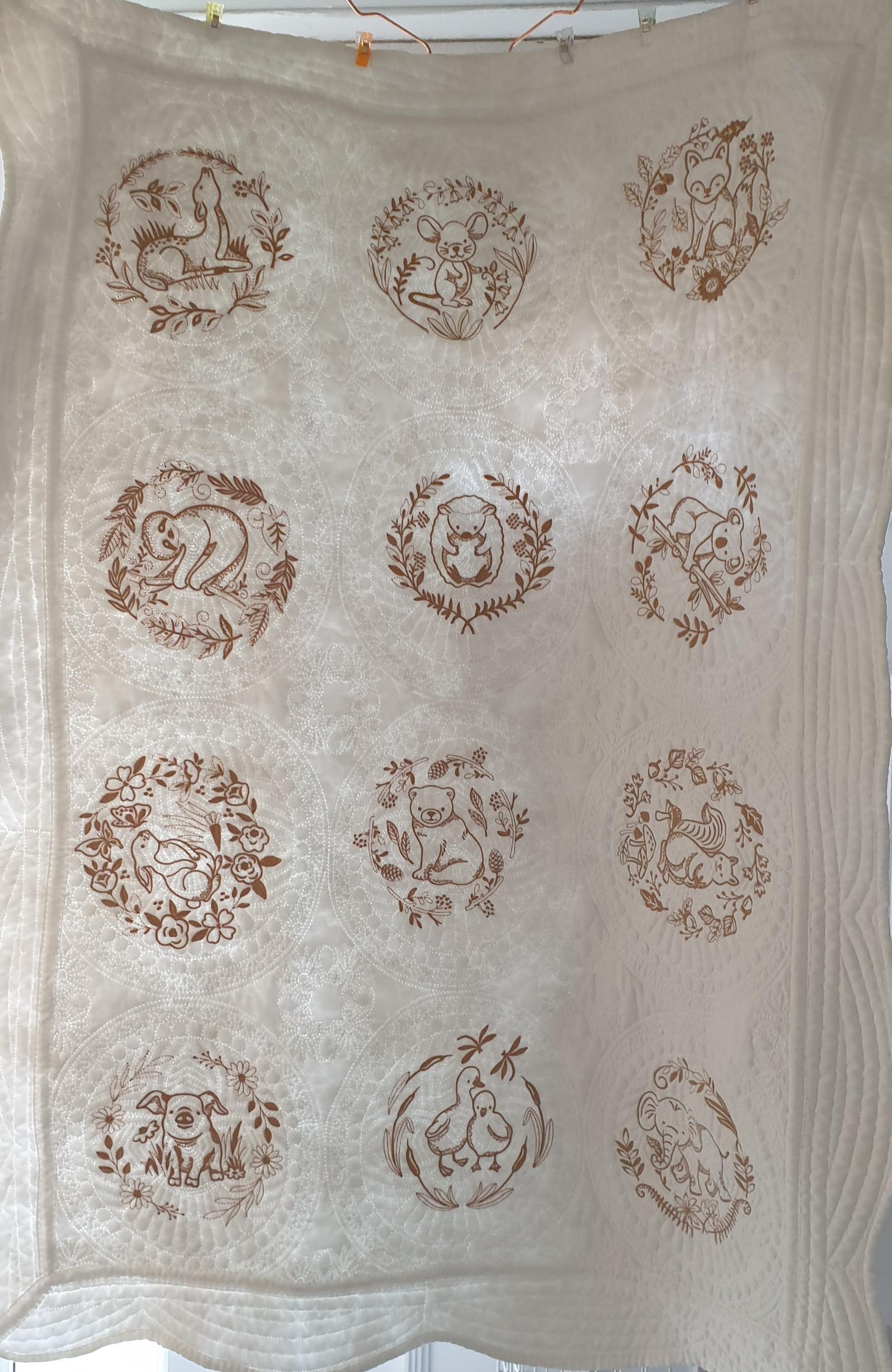 White embroidered quilt, enchanted animals